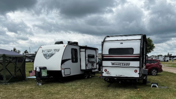 RVs parked in grass.